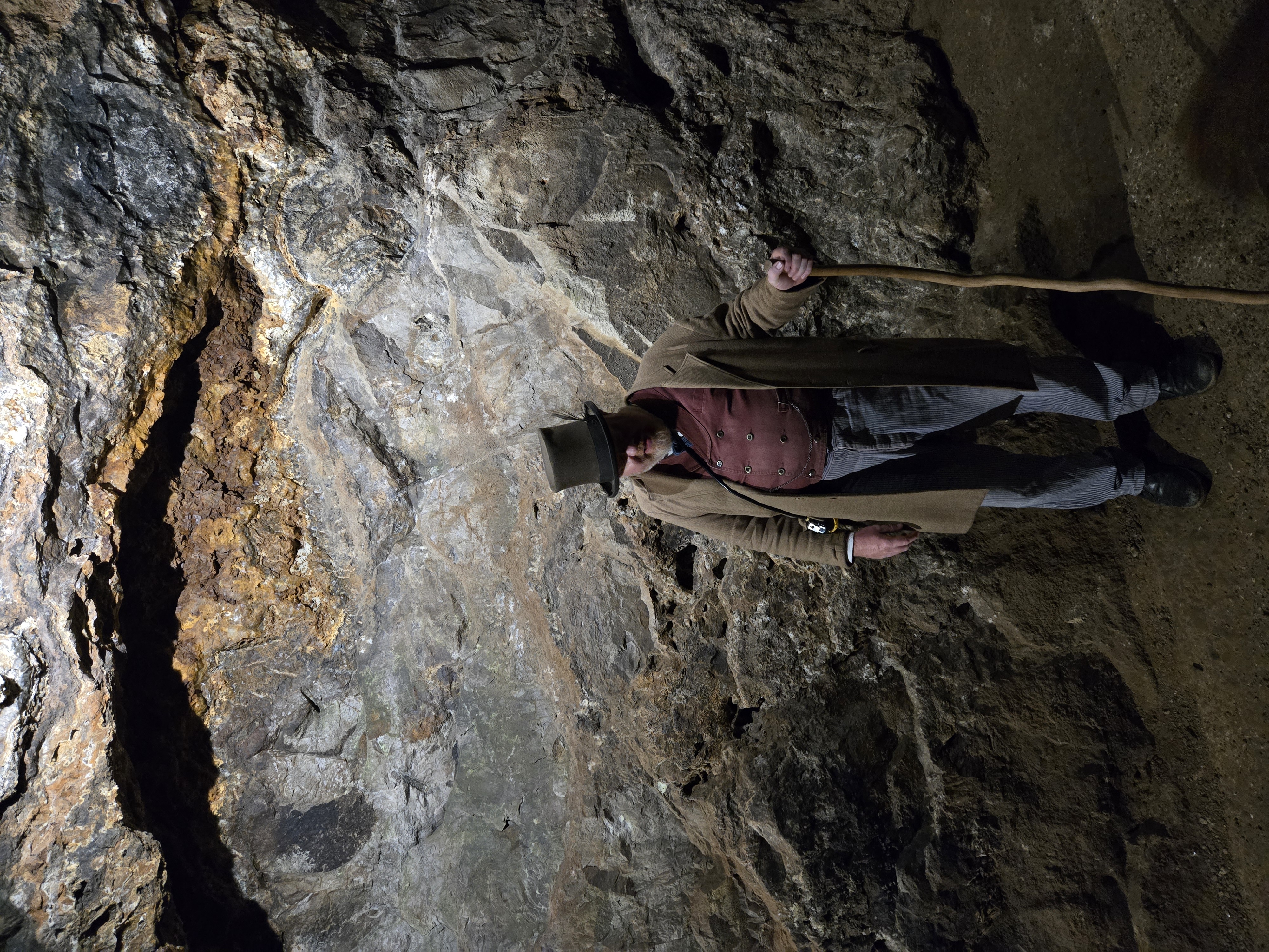 Guide in Victorian dress in cave