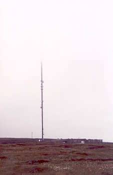 The Holme Moss transmitter rising into low cloud above the moortop summit of Holme Moss in the English Peak District