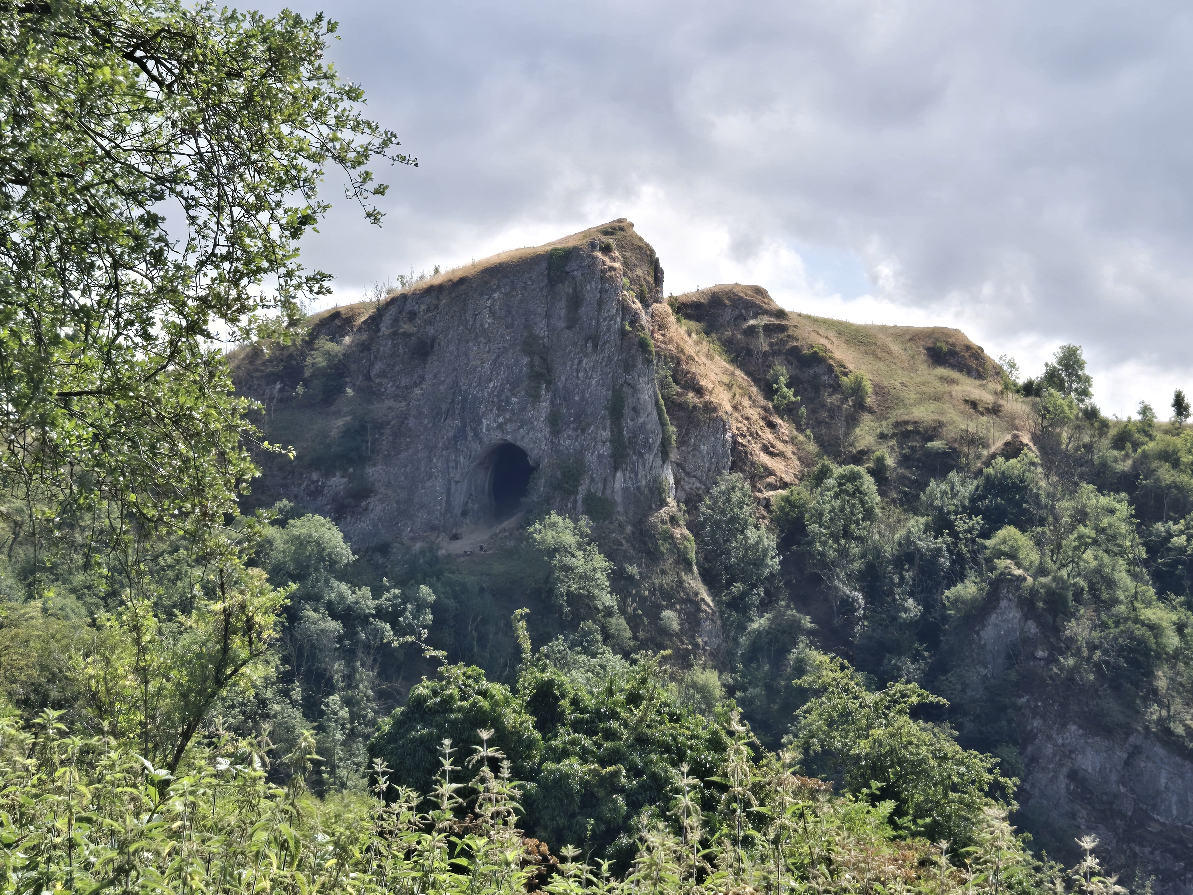 Limestone cliff with large cave entrance