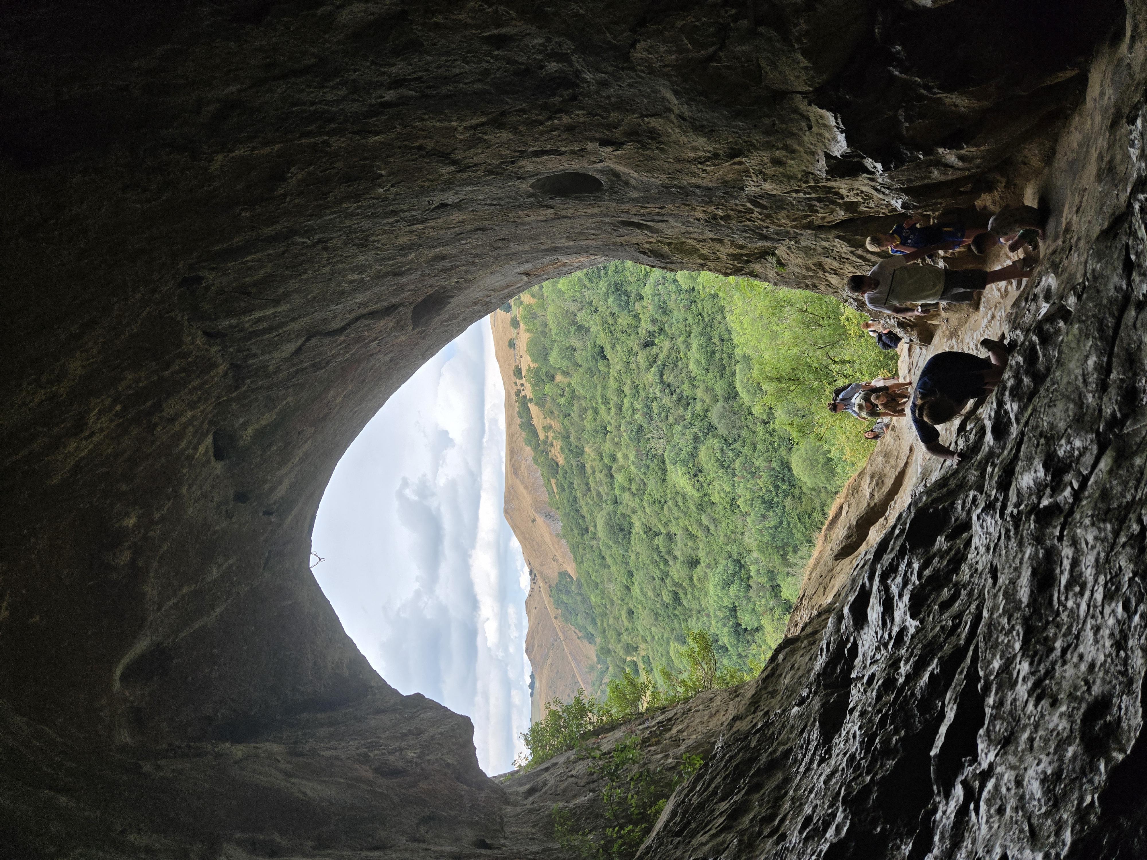 Looking out of cave entrance across valley