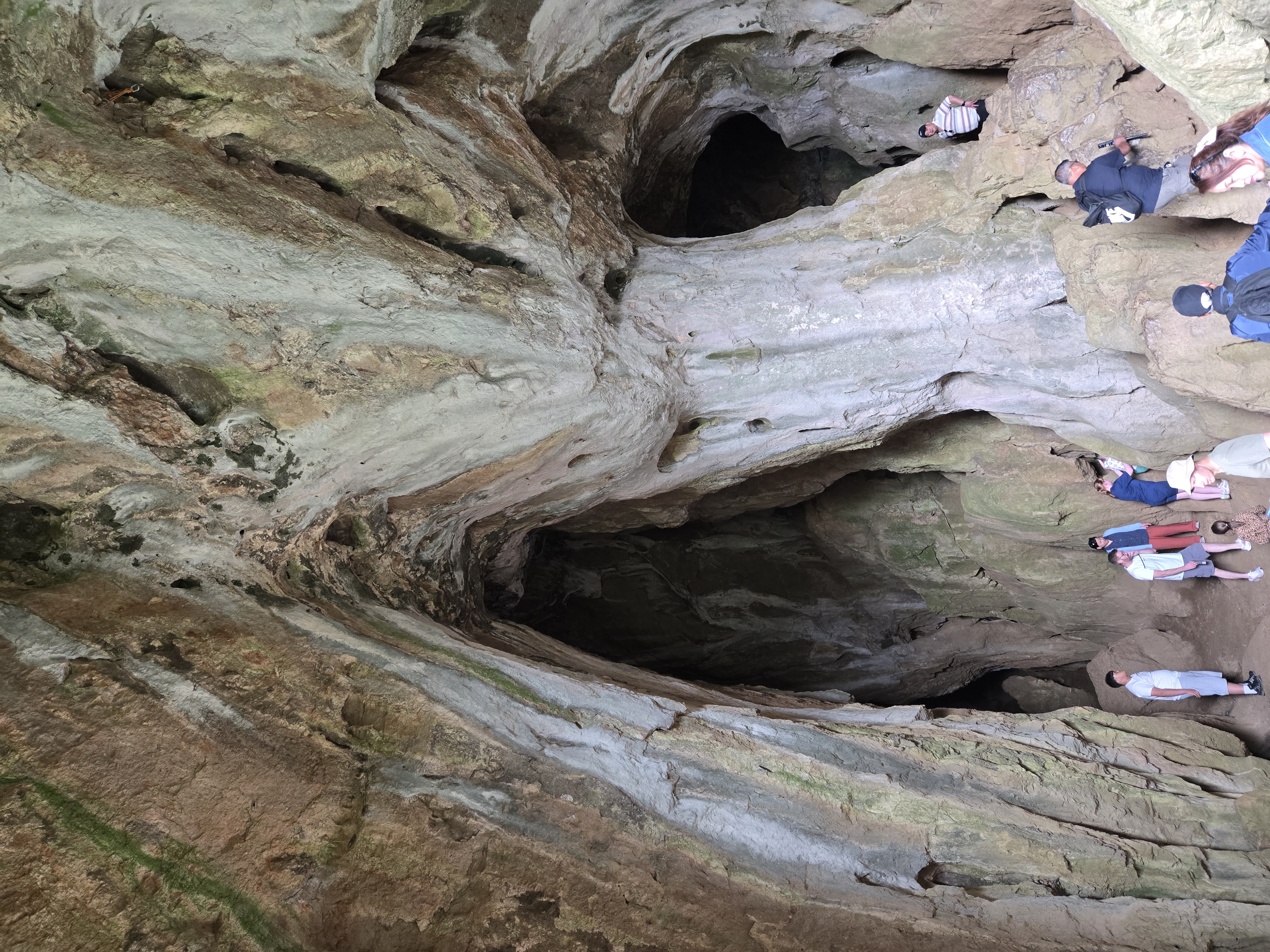 Tourists inside cave with high roof